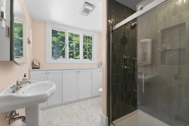 a bedroom with a bed couch and window