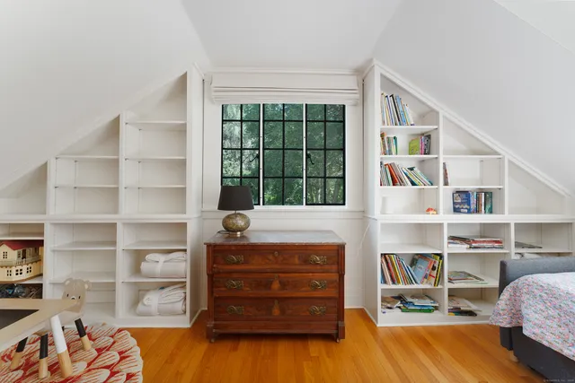 a bedroom with a bed and a book shelf