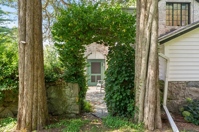 a front view of a house with a garden