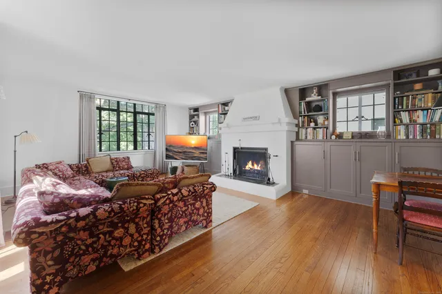 a living room with furniture fireplace and window