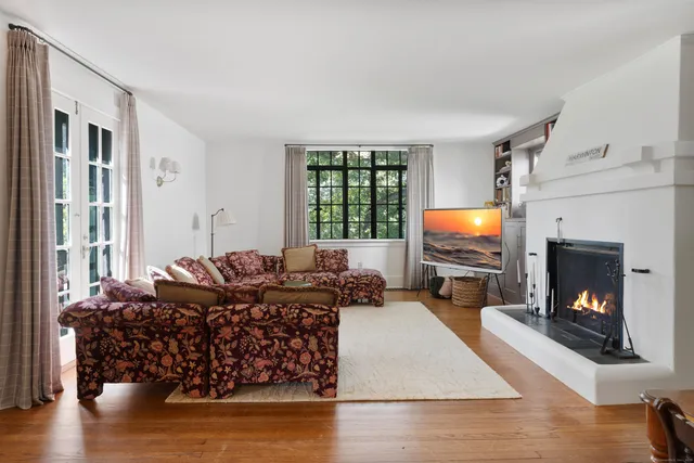 a living room with furniture fireplace and flat screen tv