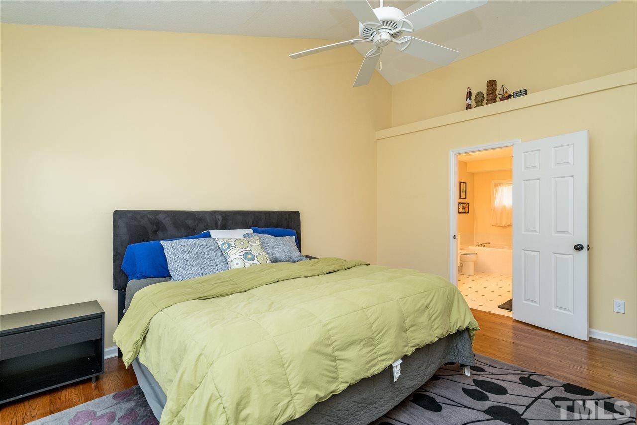 3316 Stone Castle Court Raleigh, NC 27613 - Photo 17 of 25 a bedroom with a bed and wooden floor