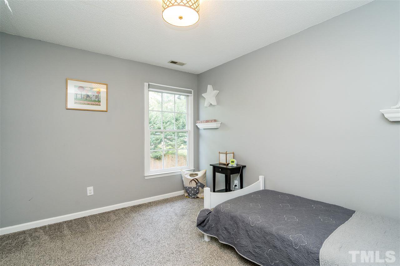 3316 Stone Castle Court Raleigh, NC 27613 - Photo 20 of 25 a bedroom with a bed and window