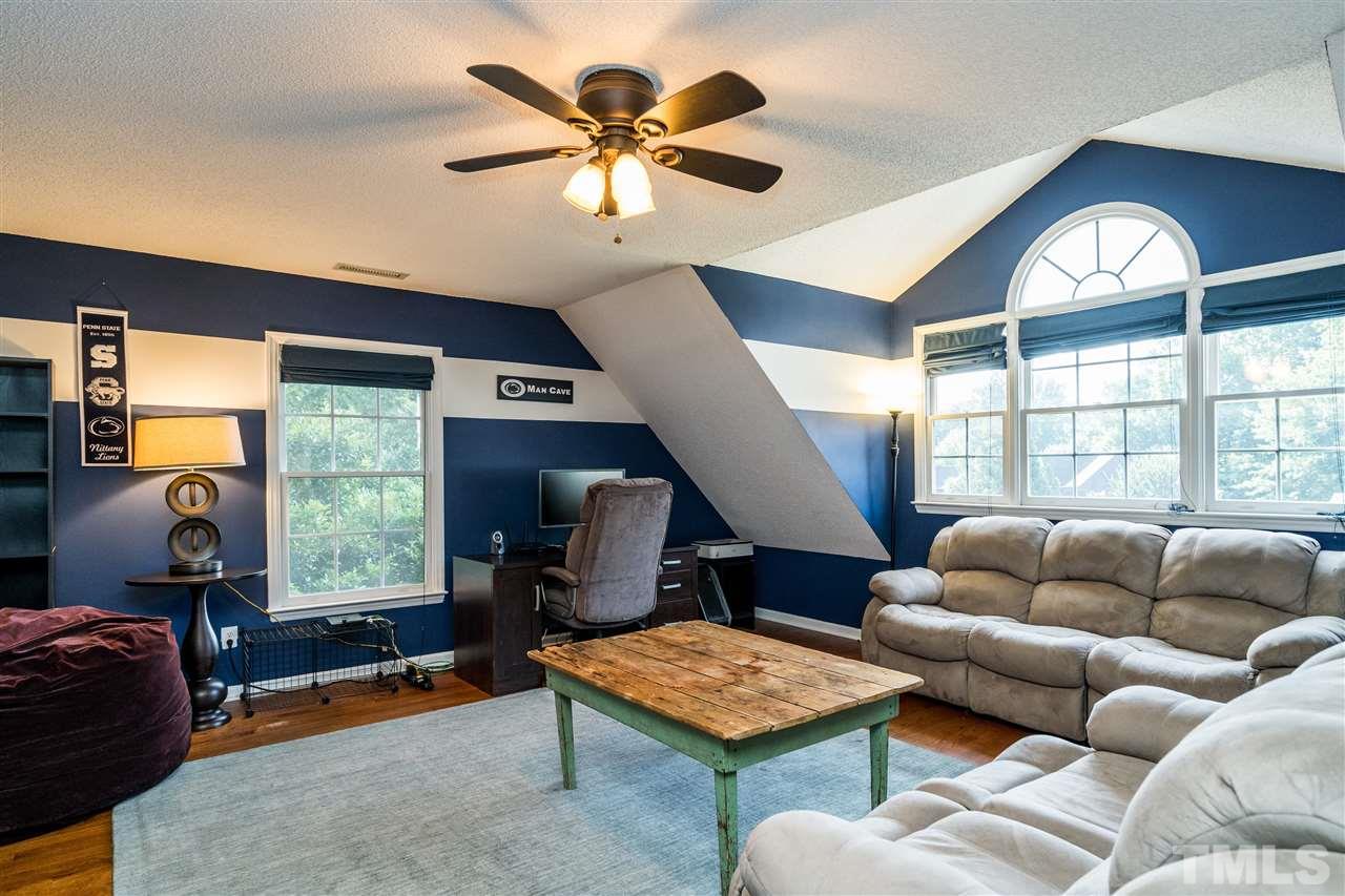 3316 Stone Castle Court Raleigh, NC 27613 - Photo 23 of 25 a living room with furniture and a window