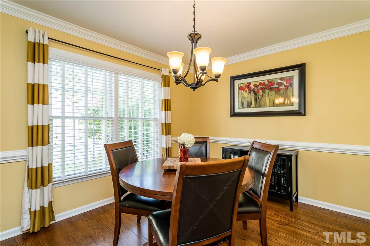 3316 Stone Castle Court Raleigh, NC 27613 - Photo 6 of 25 a view of a dining room with furniture window and wooden floor