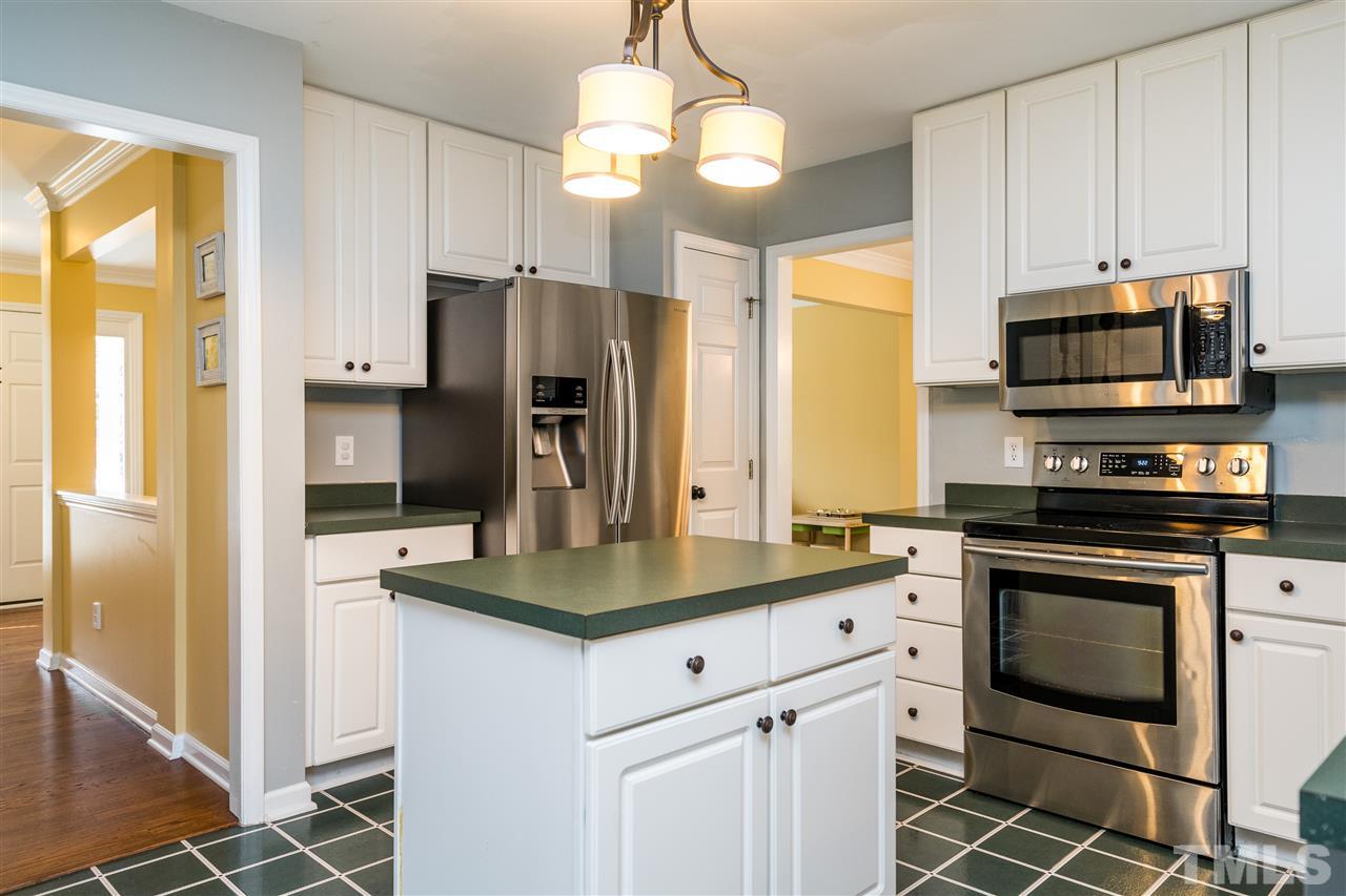3316 Stone Castle Court Raleigh, NC 27613 - Photo 8 of 25 a kitchen with stainless steel appliances a stove a refrigerator and a sink