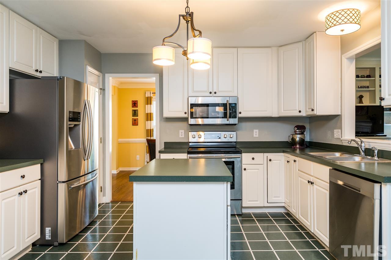 3316 Stone Castle Court Raleigh, NC 27613 - Photo 9 of 25 a kitchen with stainless steel appliances a stove refrigerator sink and microwave