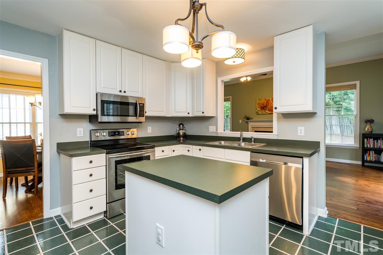 3316 Stone Castle Court Raleigh, NC 27613 - Photo 10 of 25 a kitchen with stainless steel appliances a stove a sink and a microwave