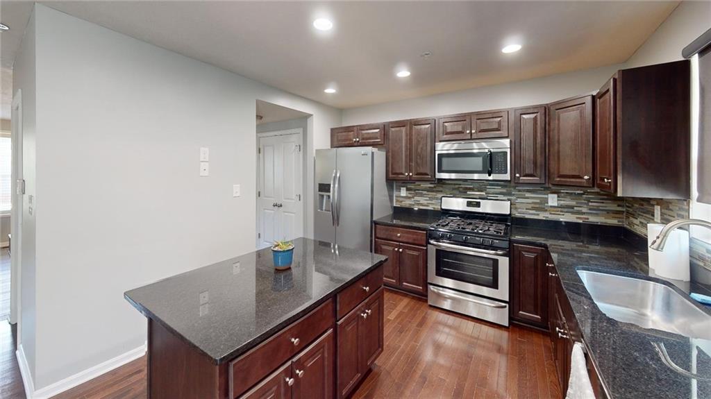 138 Watson Drive Warrendale, PA 15086 - Photo 2 of 24 a kitchen with stainless steel appliances granite countertop a sink stove and refrigerator