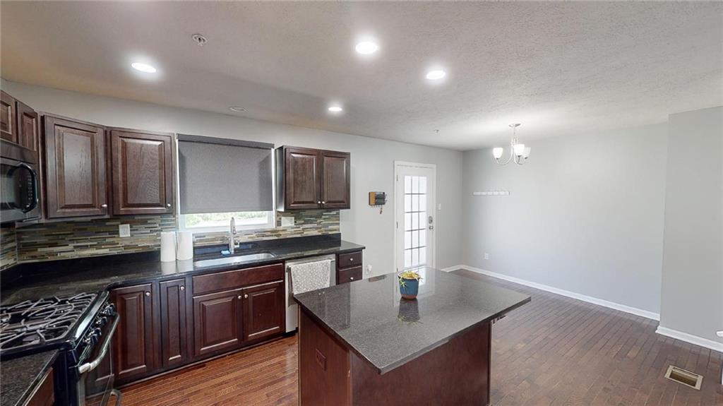 138 Watson Drive Warrendale, PA 15086 - Photo 4 of 24 a kitchen with stainless steel appliances granite countertop a sink stove and refrigerator