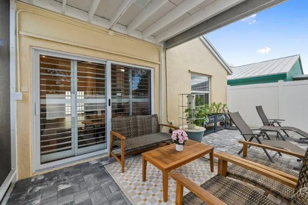 a backyard of a house with outdoor seating