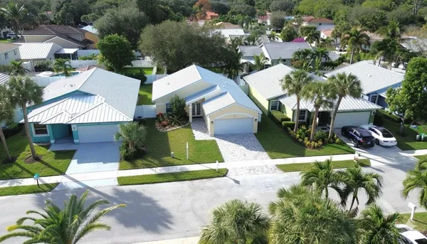 an aerial view of a house with a yard and fountain