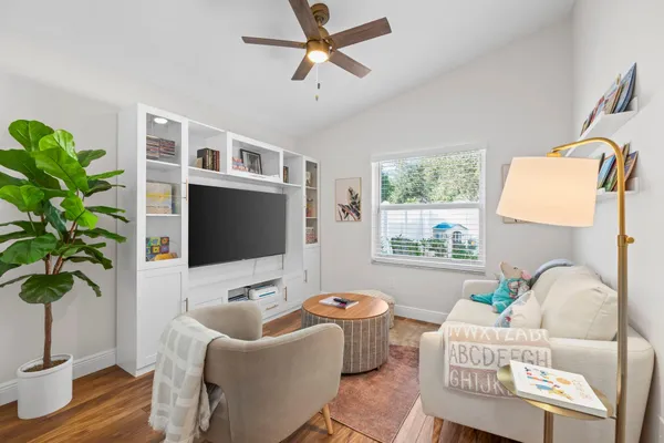 a living room with furniture potted plant and a window