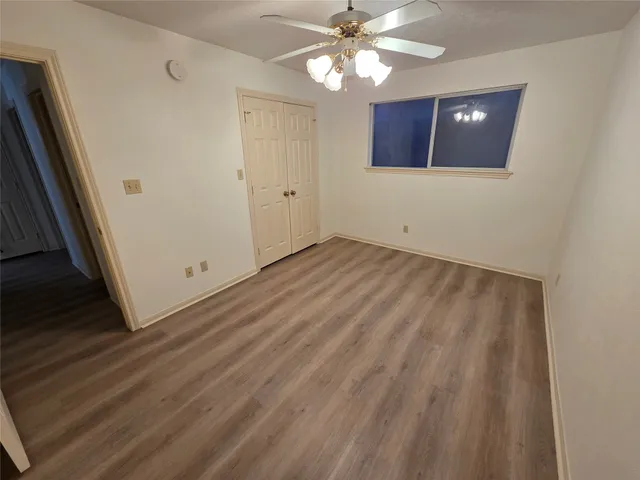 a bathroom with a granite countertop sink a mirror and toilet