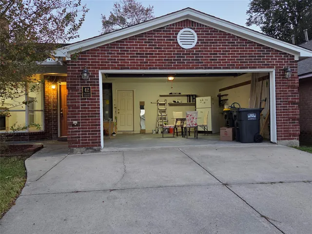 an empty room with wooden floor and chandelier