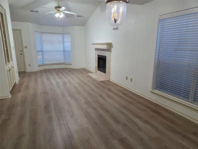 wooden floor in an empty room with a fireplace