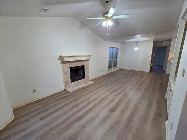 a kitchen with granite countertop a sink a stove and cabinets