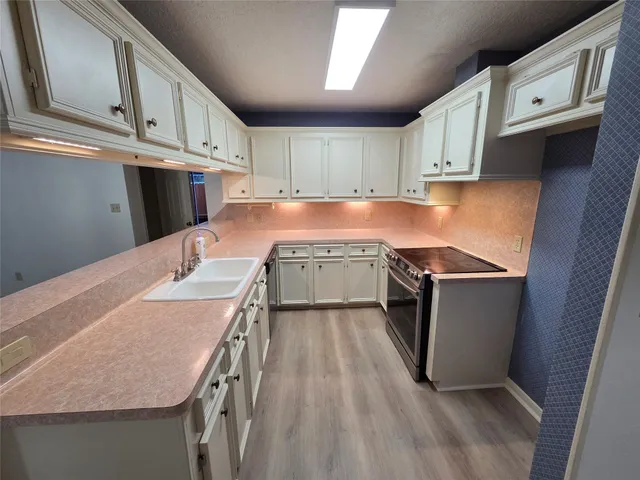 an empty room with wooden floor ceiling fan and window