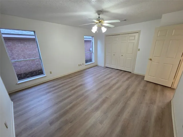a bathroom with a granite countertop sink a mirror and shower
