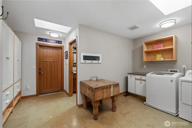 a bathroom with a granite countertop tub sink and mirror