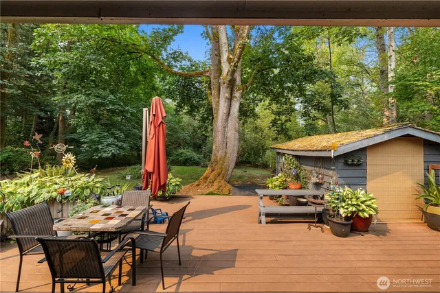 a view of a house with backyard and sitting area