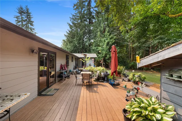 a view of a house with backyard porch and sitting area