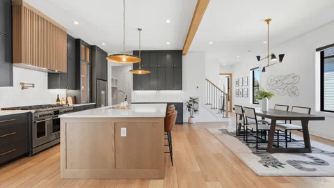 a kitchen with stainless steel appliances granite countertop a stove and a wooden floors