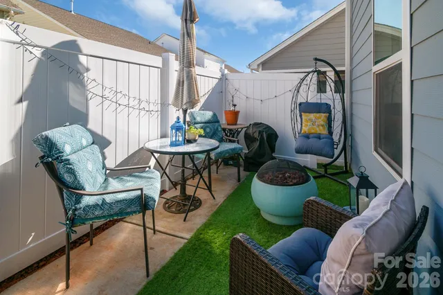 a view of a patio with couches table and chairs potted plants
