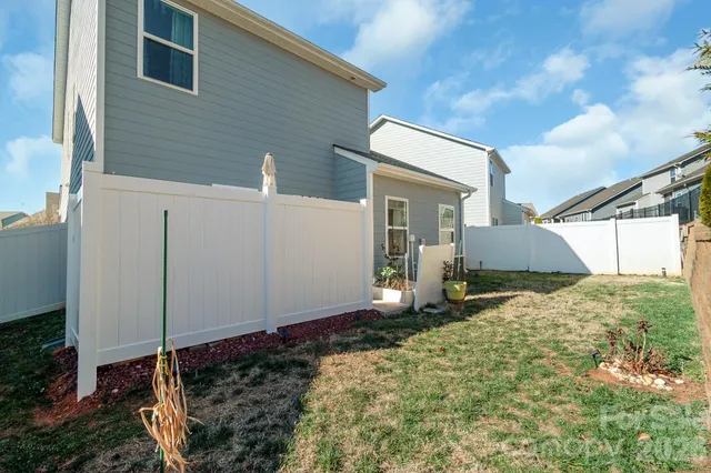 a backyard of a house with a tree