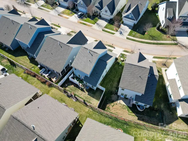 an aerial view of a house with a yard and sitting space