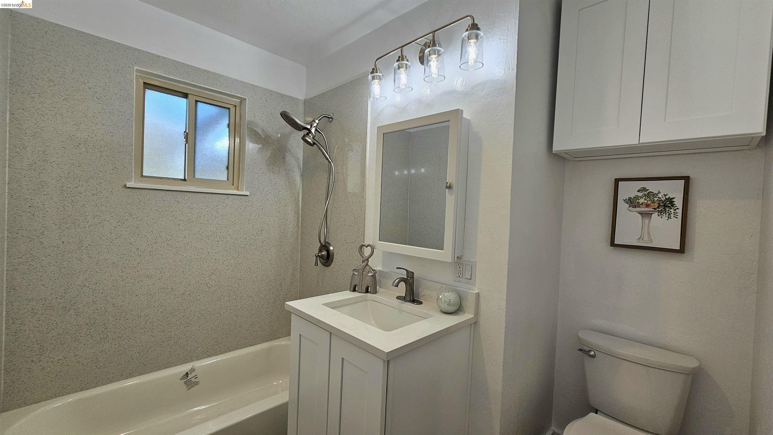 95 West Leland Road Pittsburg, CA 94565 - Photo 11 of 25 a bathroom with a sink toilet and vanity