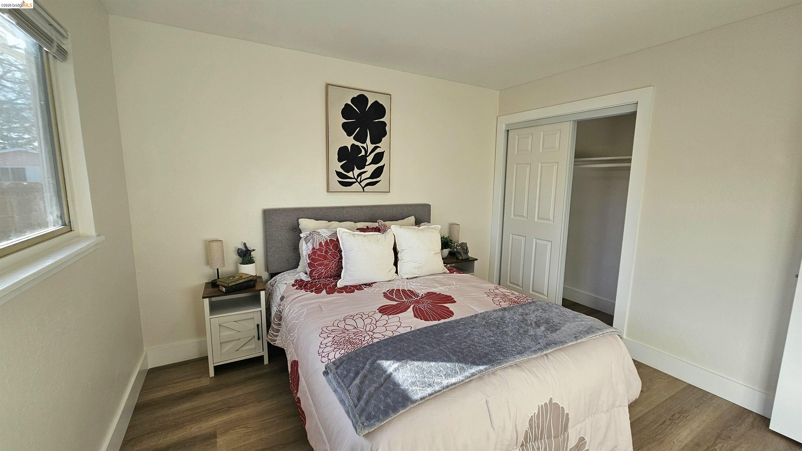 95 West Leland Road Pittsburg, CA 94565 - Photo 17 of 25 a bedroom with a bed and wooden floor