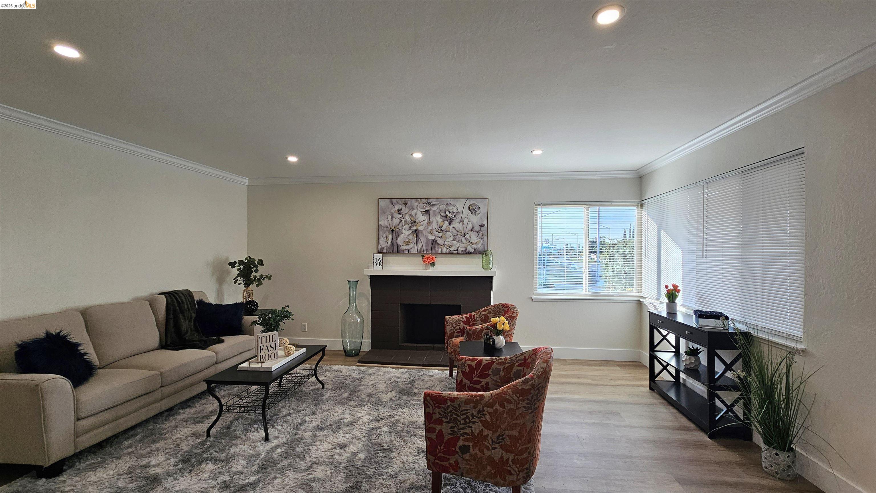 95 West Leland Road Pittsburg, CA 94565 - Photo 4 of 25 a living room with furniture two windows and a fireplace