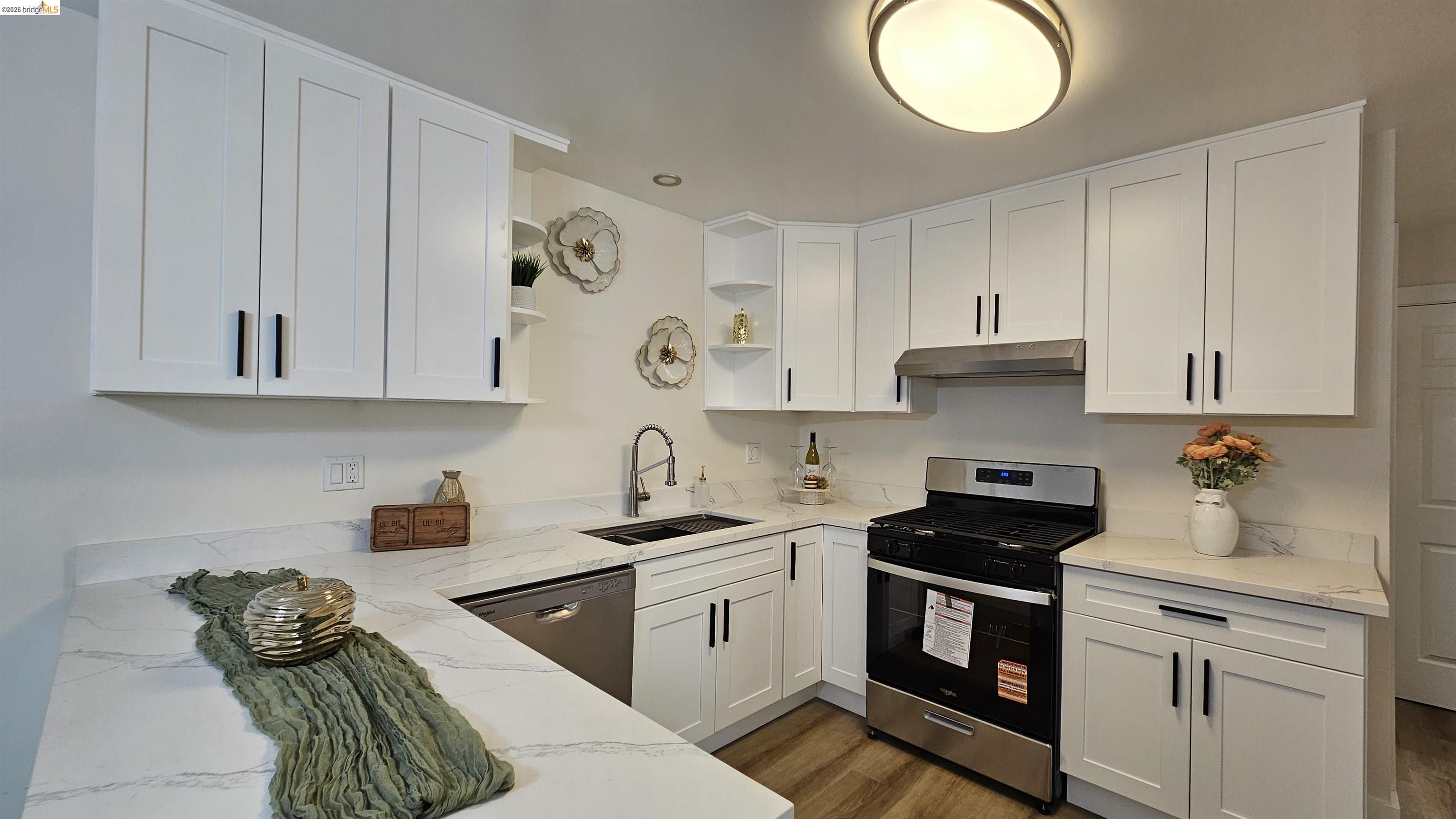 95 West Leland Road Pittsburg, CA 94565 - Photo 6 of 25 a kitchen with cabinets appliances and a sink