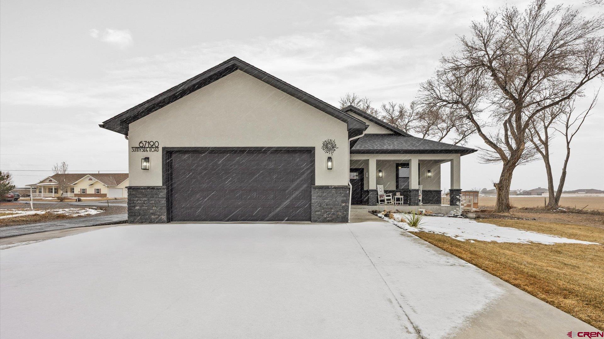 67190 Sunnyside Road Montrose, CO 81401 - Photo 5 of 41 a front view of house with yard and trees in the background