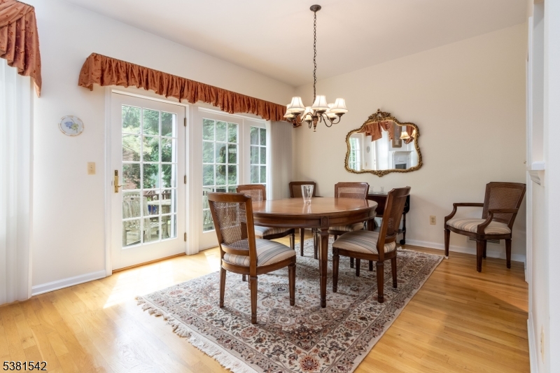 12 Hurlingham Club Road Far Hills, NJ 07931 - Photo 13 of 31 a view of a dining room with furniture a rug and wooden floor