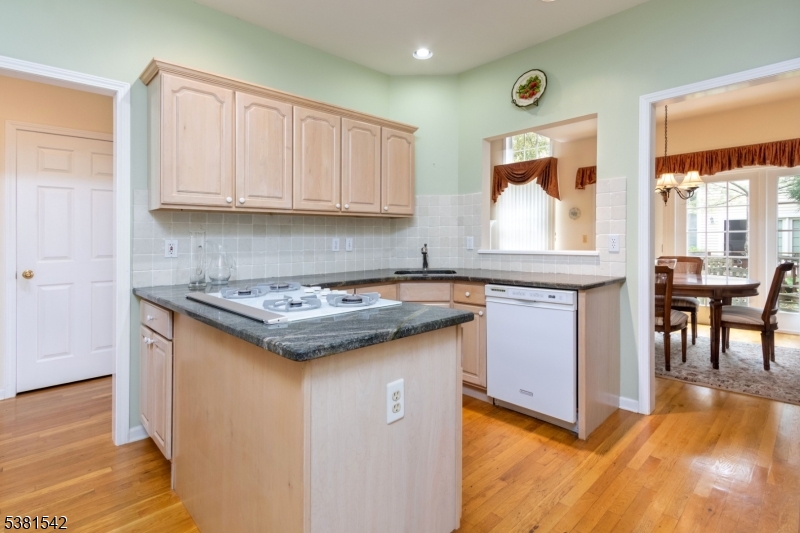 12 Hurlingham Club Road Far Hills, NJ 07931 - Photo 15 of 31 a kitchen with granite countertop a sink stove and cabinets