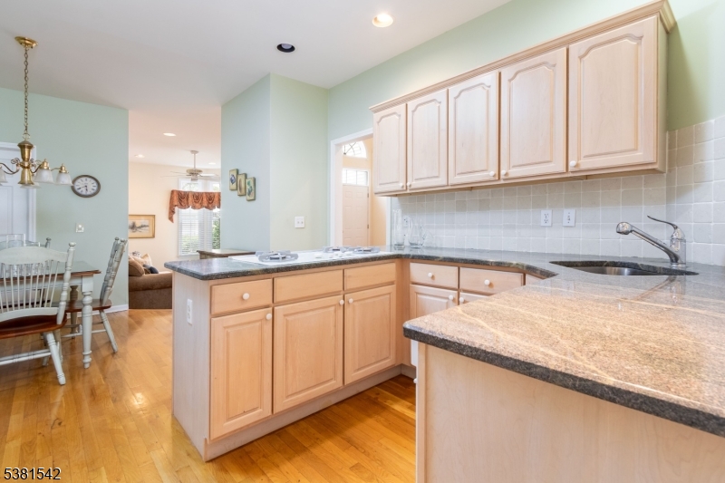 12 Hurlingham Club Road Far Hills, NJ 07931 - Photo 16 of 31 a kitchen with stainless steel appliances granite countertop a sink stove and cabinets