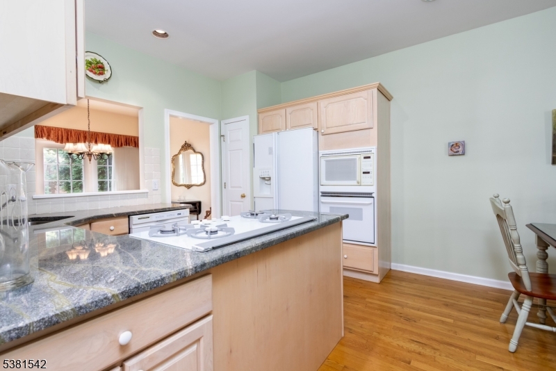 12 Hurlingham Club Road Far Hills, NJ 07931 - Photo 17 of 31 a kitchen with stainless steel appliances granite countertop a sink dishwasher and cabinets with wooden floor