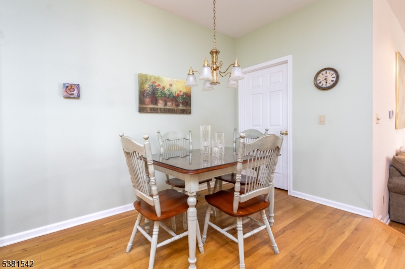 12 Hurlingham Club Road Far Hills, NJ 07931 - Photo 18 of 31 a view of a dining room with furniture and wooden floor