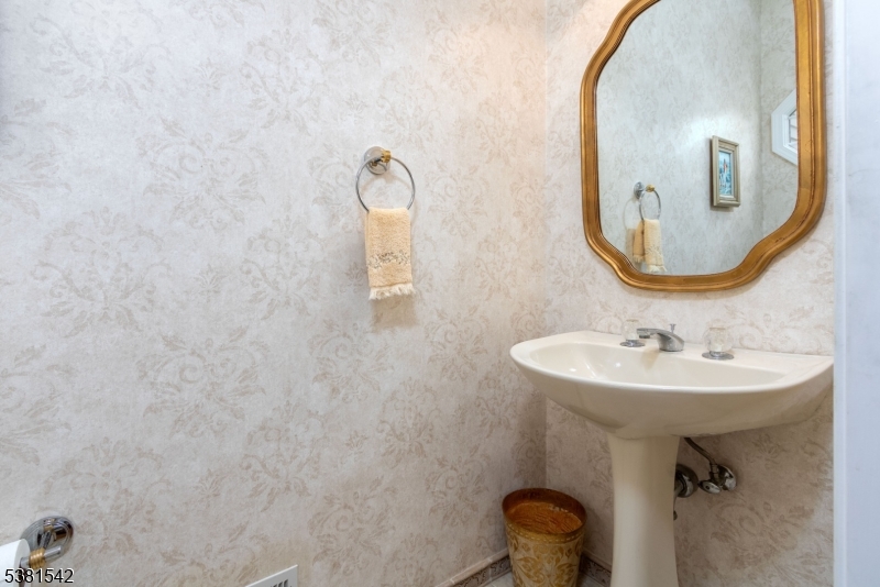 12 Hurlingham Club Road Far Hills, NJ 07931 - Photo 21 of 31 a bathroom with a sink and mirror