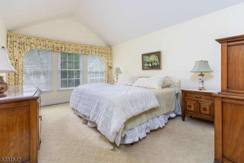 12 Hurlingham Club Road Far Hills, NJ 07931 - Photo 25 of 31 a spacious bedroom with a bed and a dresser next to a window