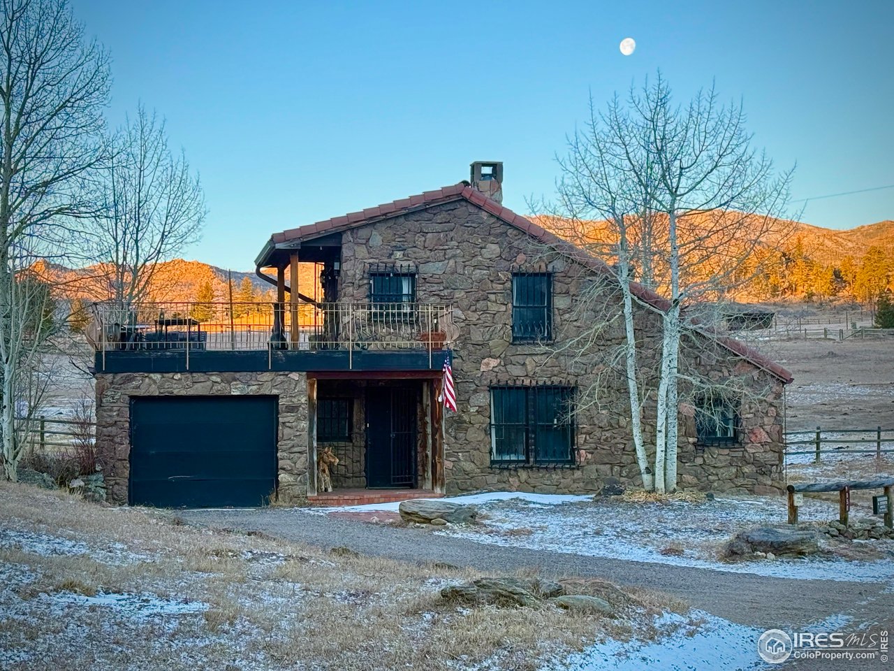 9200 Old Flowers Road Bellvue, CO 80512 - Photo 6 of 50 a front view of a house with a yard and garage