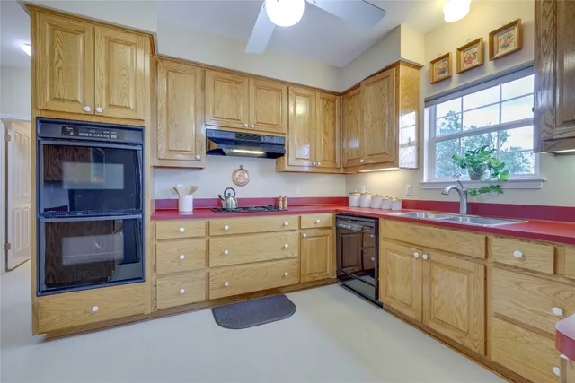 a kitchen with sink cabinets and window