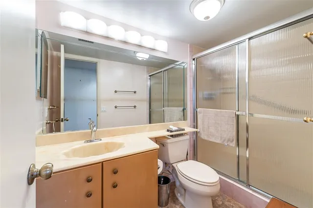 a bathroom with a sink toilet and shower