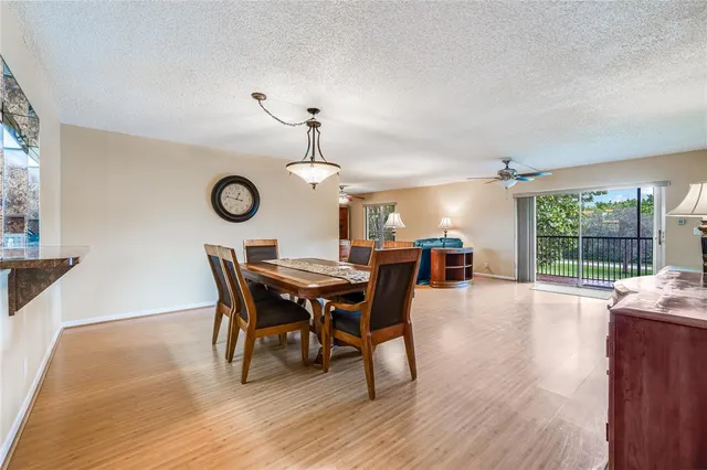 a view of a dining room with furniture wooden floor and chandelier