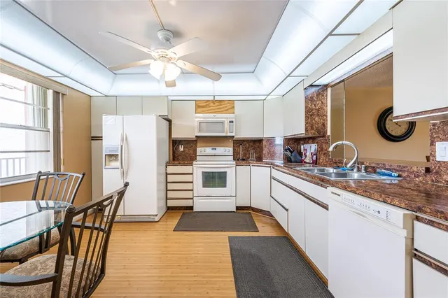 a kitchen with refrigerator and cabinets