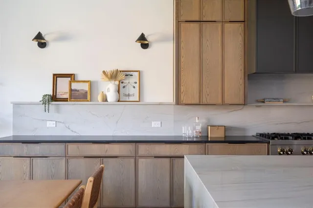 a kitchen with stainless steel appliances granite countertop a sink a stove and a microwave