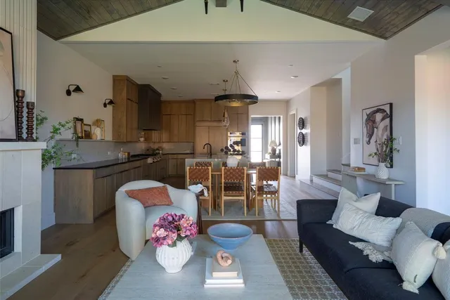 a living room with furniture and kitchen view