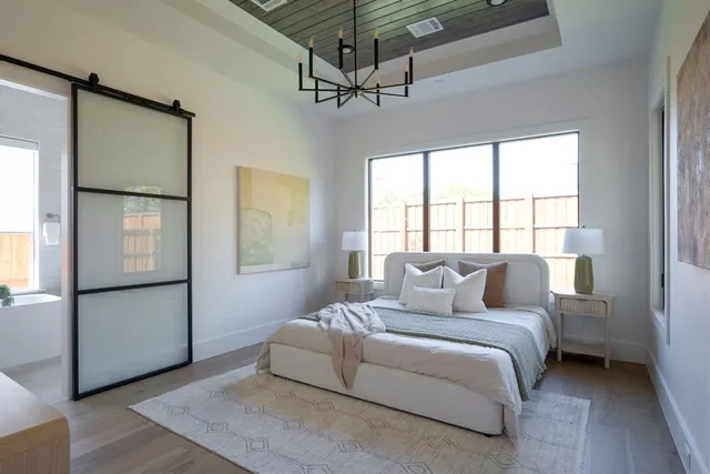 a bedroom with a large bed and a window